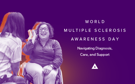 Two people having a warm conversation, one seated in a wheelchair, with text reading: World Multiple Sclerosis Awareness Day — Navigating Diagnosis, Care, and Support.