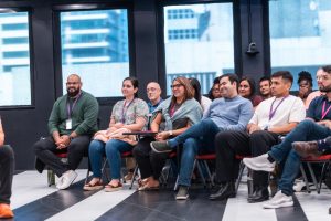 Audience members engaged and listening during an Oasis Connections Season One session at Abarca Health, featuring a diverse group of professionals in Santurce