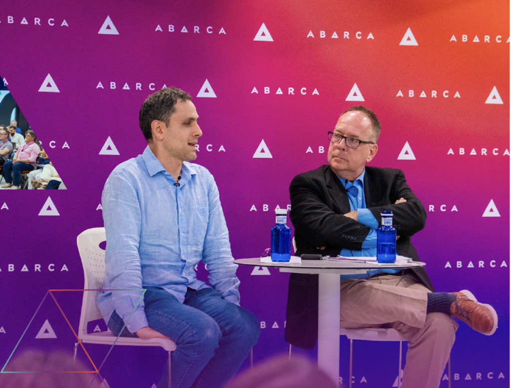 Bruce Japsen and Jason Borschow seated on stage in front of an Abarca-branded backdrop during a leadership conversation.